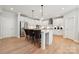 Well-appointed kitchen with white cabinetry, a center island with seating, and modern appliances at 204 Coronado Ave, Matthews, NC 28104