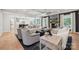 Spacious living room with a stone fireplace, modern furniture, and an open layout at 204 Coronado Ave, Matthews, NC 28104