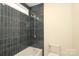 Bathroom features a shower and tub combination with blue tiled walls at 21514 Gulfstar Ct, Cornelius, NC 28031