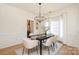Elegant dining room with a modern chandelier, a large dining table, and ample natural light at 21514 Gulfstar Ct, Cornelius, NC 28031