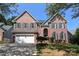 Charming two-story brick home with a manicured lawn and a two-car attached garage at 21514 Gulfstar Ct, Cornelius, NC 28031