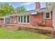 Brick back patio with steps, featuring French doors and exterior brick oven and built in grill at 2178 Tryon Courthouse Rd, Bessemer City, NC 28016