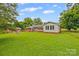 Expansive backyard view showcasing a home's back exterior with a sunroom, and shed at 2178 Tryon Courthouse Rd, Bessemer City, NC 28016