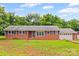 Traditional brick home featuring a symmetrical design, multiple windows, and an attached garage at 2178 Tryon Courthouse Rd, Bessemer City, NC 28016