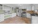Kitchen boasts stainless steel appliances, white cabinets, and a built-in desk area at 2178 Tryon Courthouse Rd, Bessemer City, NC 28016