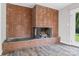 Living room features a brick fireplace with modern flooring and light gray walls at 2178 Tryon Courthouse Rd, Bessemer City, NC 28016