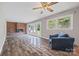 Comfortable living room featuring a brick fireplace, hardwood floors, a ceiling fan and French doors at 2178 Tryon Courthouse Rd, Bessemer City, NC 28016