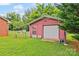 Exterior view of a detached outbuilding with a garage door and a side entrance at 2178 Tryon Courthouse Rd, Bessemer City, NC 28016
