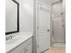 Well-lit bathroom featuring a vanity with a black framed mirror and a glass-enclosed shower at 2527 Fossil Stone Ln, Fort Mill, SC 29708