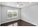 Bright bedroom with hardwood floors, a ceiling fan and a large window at 2527 Fossil Stone Ln, Fort Mill, SC 29708