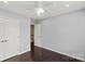 Neutral bedroom with hardwood floors, ceiling fan, and closet doors at 2527 Fossil Stone Ln, Fort Mill, SC 29708