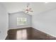 Bright and airy bedroom featuring hardwood floors and a large window for natural light at 2527 Fossil Stone Ln, Fort Mill, SC 29708
