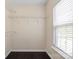 Walk-in closet with shelving, hardwood floors, and a window for natural light at 2527 Fossil Stone Ln, Fort Mill, SC 29708