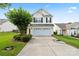 Charming two-story home with attached garage, manicured lawn, and mature shade tree enhancing curb appeal at 2527 Fossil Stone Ln, Fort Mill, SC 29708