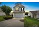 Charming two-story home with a two-car garage and well-maintained lawn, captured during the evening at 2527 Fossil Stone Ln, Fort Mill, SC 29708
