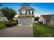Charming two-story home boasts an attached garage, manicured lawn, and inviting curb appeal at 2527 Fossil Stone Ln, Fort Mill, SC 29708