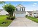 Charming two-story home boasts an attached garage, manicured lawn, and inviting curb appeal at 2527 Fossil Stone Ln, Fort Mill, SC 29708
