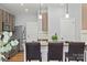 This kitchen showcases stainless steel appliances, granite countertops, and stylish pendant lighting at 2527 Fossil Stone Ln, Fort Mill, SC 29708