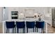 Kitchen island with white countertop and dark blue chairs, stainless steel appliances at 2541 Mabel Ln, Monroe, NC 28110