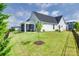 Spacious backyard with green grass, a black fence, and a screened porch at 264 Auburn View Rd, Rock Hill, SC 29730