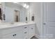 Bright bathroom featuring double sink vanity with white cabinets and a large mirror at 264 Auburn View Rd, Rock Hill, SC 29730