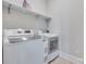 Bright laundry room with a washing machine, a dryer, and a shelf at 264 Auburn View Rd, Rock Hill, SC 29730