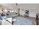 Open living room showcases hardwood floors, modern ceiling fan, with a view into the kitchen and white sofa at 264 Auburn View Rd, Rock Hill, SC 29730