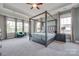 Serene main bedroom featuring a four-poster bed, soft lighting, and large windows with peaceful views at 264 Auburn View Rd, Rock Hill, SC 29730