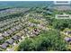 Aerial view of the neighborhood's central park and Amenity Center surrounded by beautiful homes and trees at 2972 Arches Bluff Cir, Lancaster, SC 29720