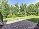 Enjoy the outdoors on this stone paver patio with beautiful lawn and mature trees beyond at 2972 Arches Bluff Cir, Lancaster, SC 29720