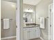 Well-lit bathroom featuring granite counters, white cabinets and modern fixtures. Perfect for a refreshing start to your day at 2972 Arches Bluff Cir, Lancaster, SC 29720