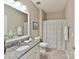 Neutral bathroom featuring a vanity with granite counter, white cabinets, toilet, and bathtub with shower at 2972 Arches Bluff Cir, Lancaster, SC 29720