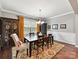 Elegant dining room with a wooden table, decorative rug, and stylish chairs at 2972 Arches Bluff Cir, Lancaster, SC 29720