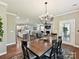 Open-concept dining room showcasing views of kitchen and living room, with seating for six at 2972 Arches Bluff Cir, Lancaster, SC 29720
