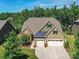 Well maintained two-story home with manicured lawn, mature trees, and a three-car garage at 2972 Arches Bluff Cir, Lancaster, SC 29720