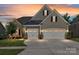 Charming home with a two-car garage, stone accents and manicured lawn at 2972 Arches Bluff Cir, Lancaster, SC 29720