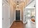 Welcoming foyer showcasing hardwood floors, an elegant light fixture, and a glimpse into the living area at 2972 Arches Bluff Cir, Lancaster, SC 29720