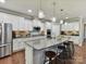 Modern kitchen with granite countertops, stainless steel appliances, pendant lighting, and breakfast bar seating at 2972 Arches Bluff Cir, Lancaster, SC 29720