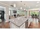 Open-concept kitchen with a granite countertop island with seating and stainless steel appliances at 2972 Arches Bluff Cir, Lancaster, SC 29720
