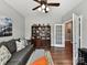 Comfortable living room featuring a gray sofa, decorative pillows, and hardwood floors at 2972 Arches Bluff Cir, Lancaster, SC 29720