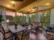 A relaxing screened porch with comfortable seating and dining areas, perfect for enjoying outdoor living at 2972 Arches Bluff Cir, Lancaster, SC 29720