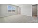 Bedroom with neutral carpet, natural light, and walk-in closet at 308 Alameda Way, Matthews, NC 28104