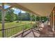 Relaxing back porch with ample room for seating and overlooks the vast, green lawn and surrounding mature trees at 321 York Southern Rd, Fort Mill, SC 29715