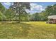 Expansive backyard with mature trees and sprawling lawn, creates a private oasis for relaxation and outdoor living at 321 York Southern Rd, Fort Mill, SC 29715
