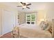 Bedroom with hardwood floors, ceiling fan, large window, and built-in shelving at 321 York Southern Rd, Fort Mill, SC 29715