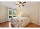 Bright bedroom with hardwood floors, ceiling fan, and large window with a view at 321 York Southern Rd, Fort Mill, SC 29715