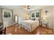 Bedroom with hardwood floors, ceiling fan, and two large windows with natural light at 321 York Southern Rd, Fort Mill, SC 29715