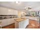 Open kitchen with island and granite countertops offers a blend of style and functionality at 321 York Southern Rd, Fort Mill, SC 29715