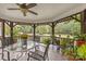 A cozy screened-in porch with tile flooring, a ceiling fan, and lots of plants creates a tranquil outdoor living space at 321 York Southern Rd, Fort Mill, SC 29715