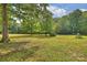 Expansive lawn featuring large shade trees is ideal for recreational activities and enjoying the natural surroundings at 321 York Southern Rd, Fort Mill, SC 29715